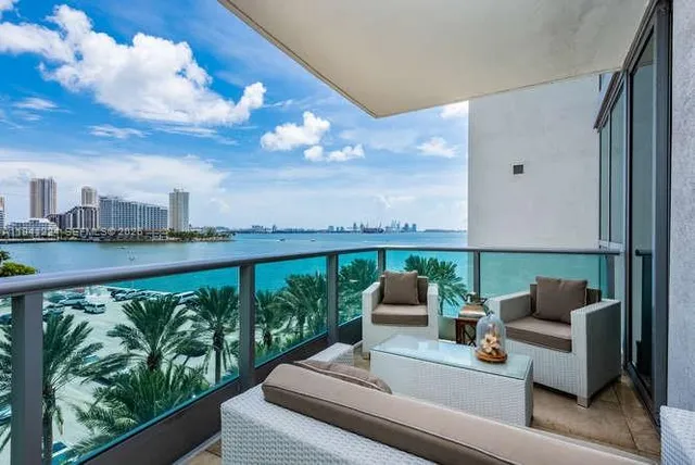 a view of balcony with couches and wooden floor