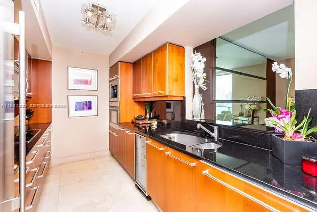 a kitchen with a sink stove and refrigerator