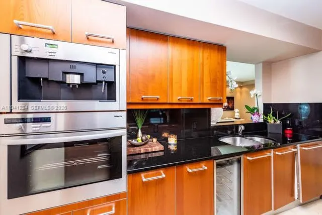 a kitchen with stainless steel appliances a sink stove and cabinets