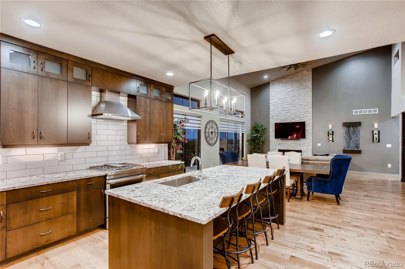 2147 Picture Point Drive Windsor, CO 80550 - Photo 18 of 39 a kitchen with granite countertop a table chairs sink and wooden floor