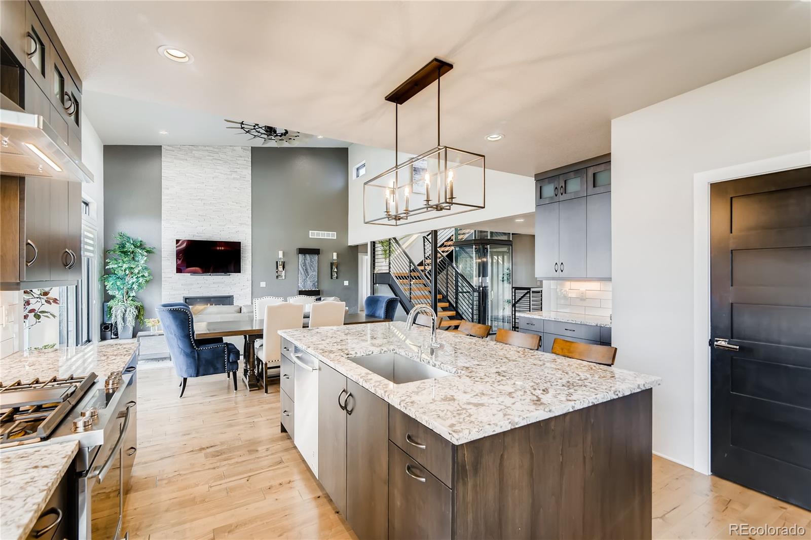 2147 Picture Point Drive Windsor, CO 80550 - Photo 19 of 39 a large kitchen with kitchen island a counter space a sink a stove and chairs