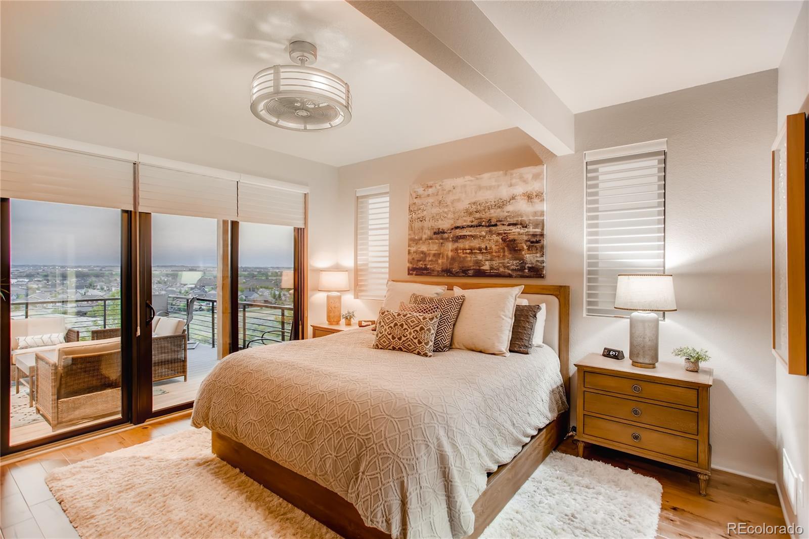 2147 Picture Point Drive Windsor, CO 80550 - Photo 22 of 39 a bedroom with a large bed and a lamp on table