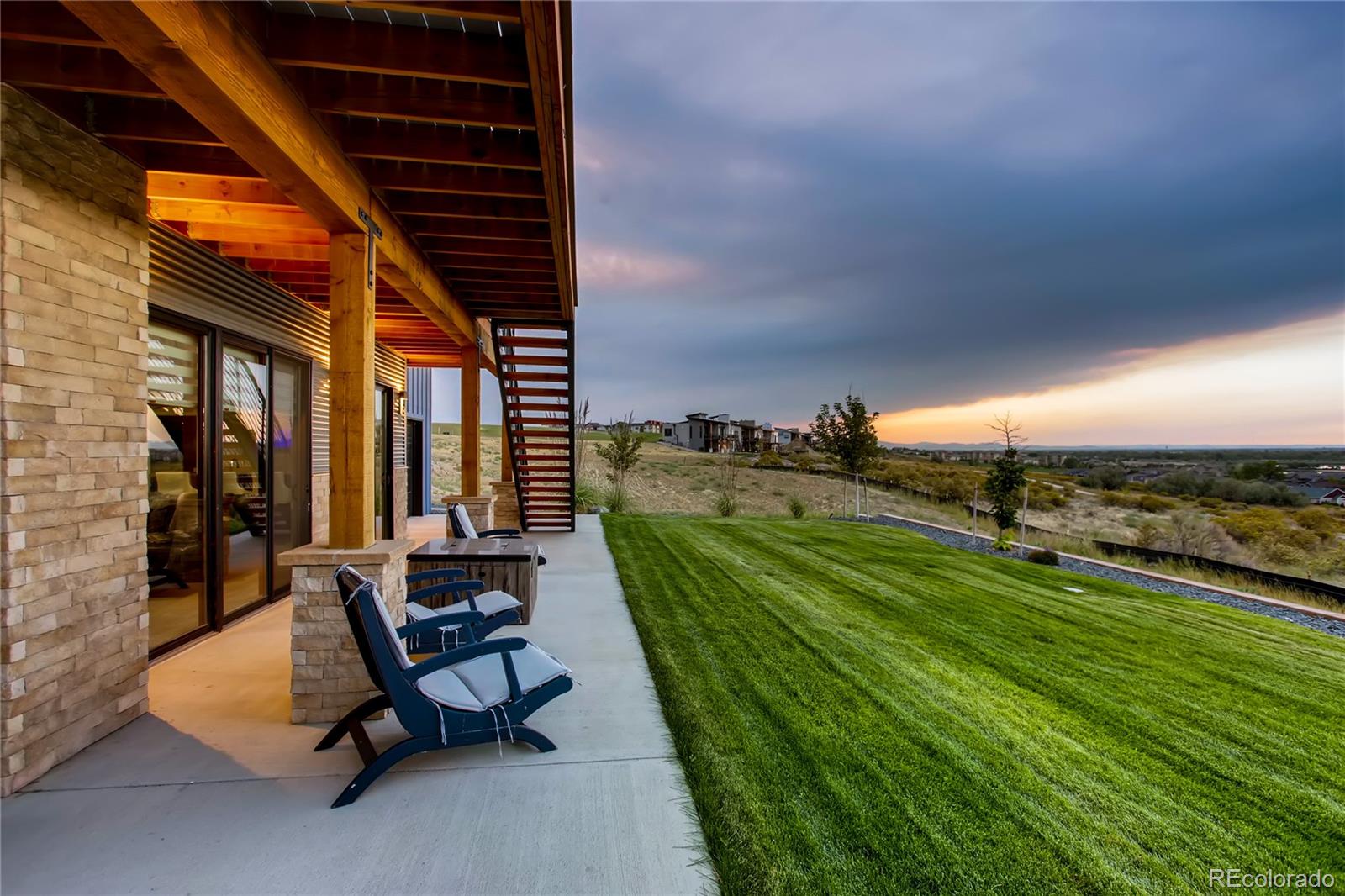 2147 Picture Point Drive Windsor, CO 80550 - Photo 35 of 39 a view of a patio with a table chairs and a backyard