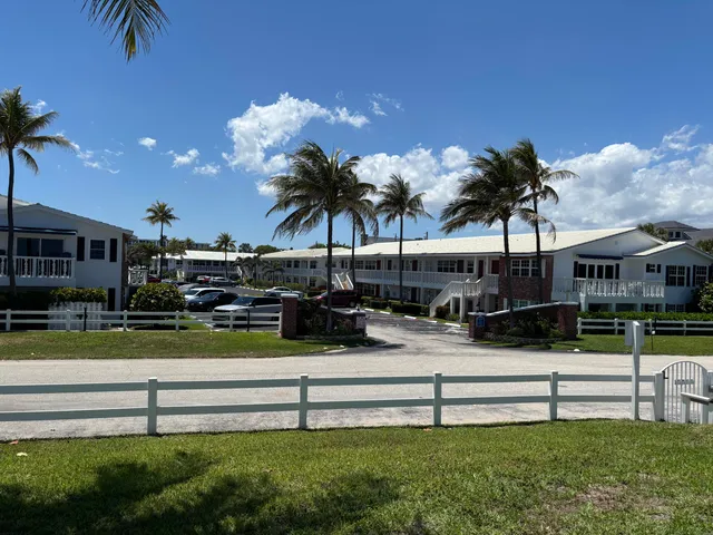 a view of swimming pool with outdoor seating and a garden