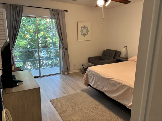 a bed sitting in a bedroom next to a window