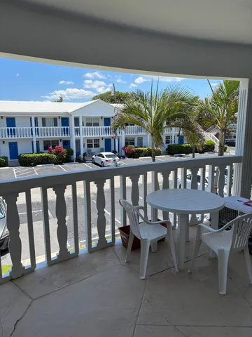 a view of a chairs and table in patio