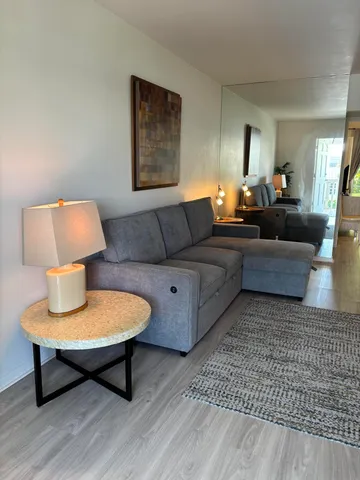 a living room with furniture and a lamp