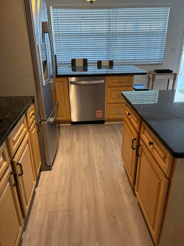 a view of a room with wooden floor