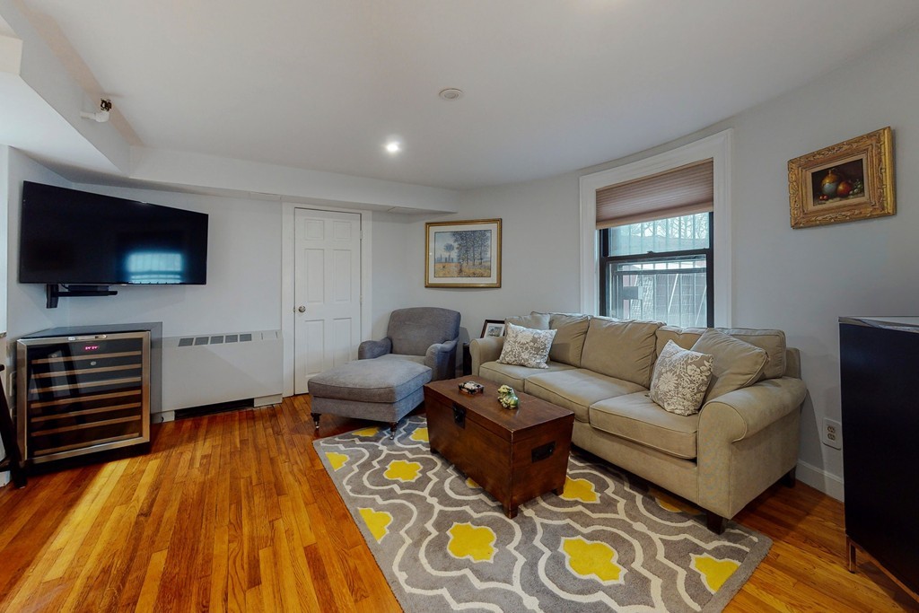 242 Beacon Street, Unit 2 Boston, MA 02116 - Photo 5 of 10 a living room with furniture and a flat screen tv