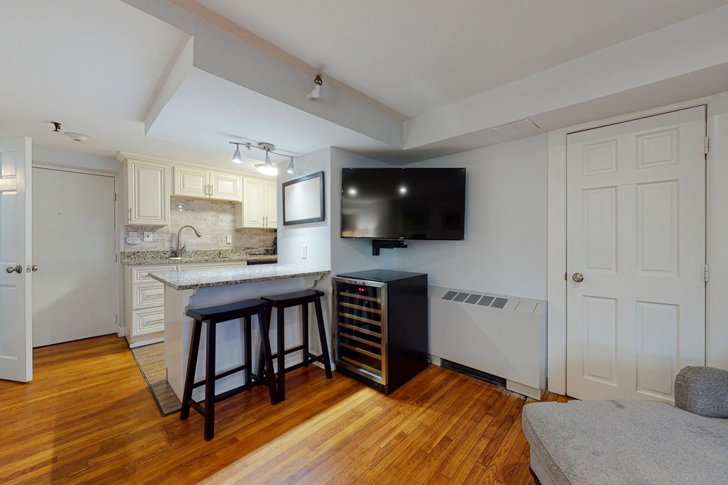 242 Beacon Street, Unit 2 Boston, MA 02116 - Photo 6 of 10 a bedroom with furniture and a flat screen tv