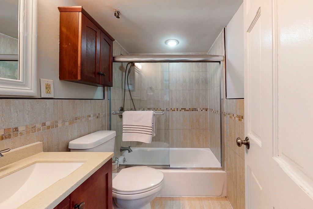 242 Beacon Street, Unit 2 Boston, MA 02116 - Photo 8 of 10 a bathroom with a sink toilet and shower