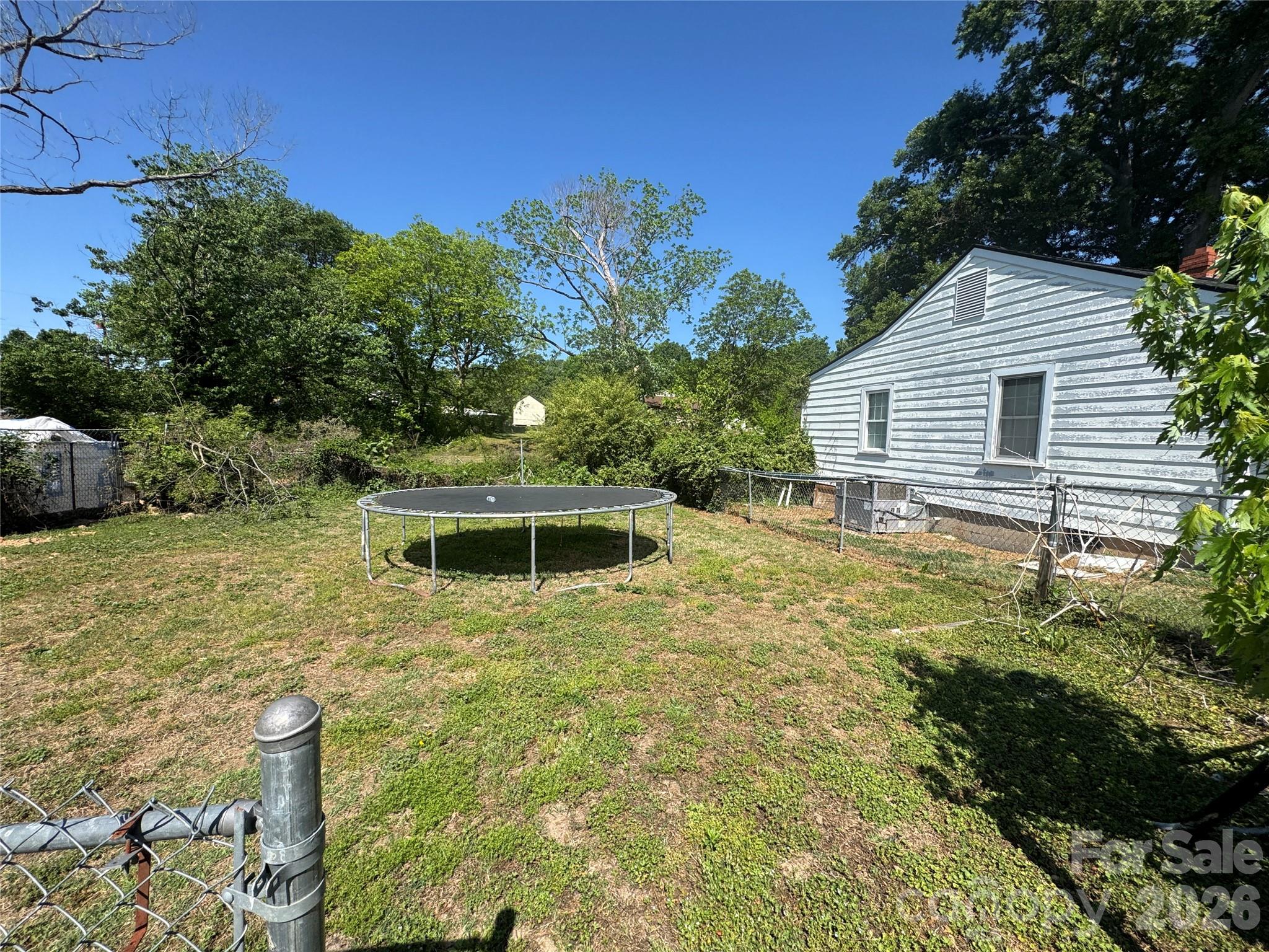 1405 Hickory Grove Road Gastonia, NC 28056 - Photo 4 of 15 a backyard of a house with table and chairs
