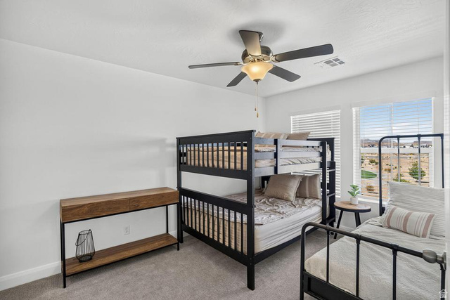 5898 Jasper Rdg Drive St. George, UT 84790 - Photo 25 of 41 Carpeted room featuring white walls, dual windows with horizontal blinds, and a built-in ceiling fan with integrated lighting