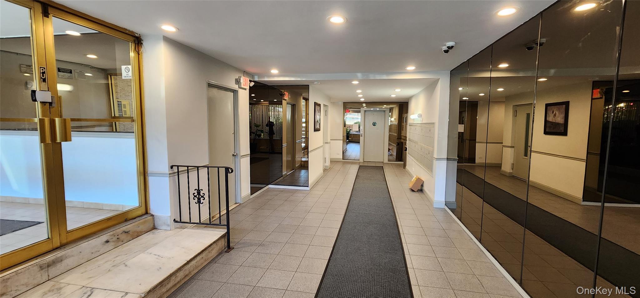 222-89 Braddock Avenue, Unit 5A Queens, NY 11428 - Photo 2 of 9 a view of a hallway with wooden floor and a bathroom