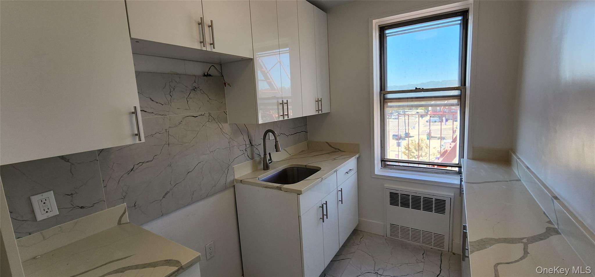 222-89 Braddock Avenue, Unit 5A Queens, NY 11428 - Photo 3 of 9 a bathroom with a sink and a window