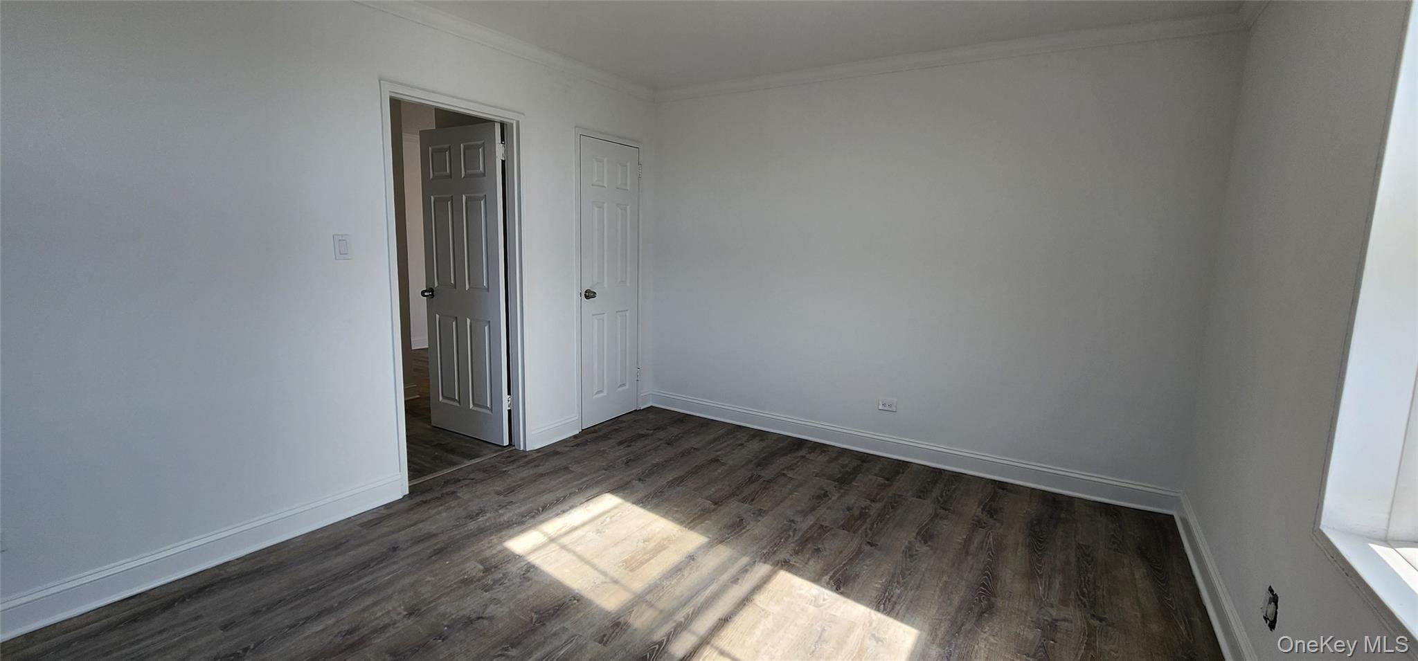 222-89 Braddock Avenue, Unit 5A Queens, NY 11428 - Photo 9 of 9 a view of an empty room and wooden floor