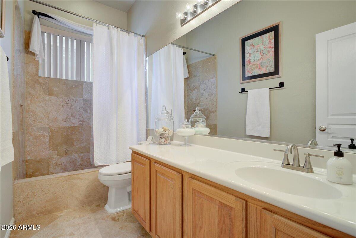 4906 East Wagoner Road Scottsdale, AZ 85254 - Photo 16 of 29 a bathroom with a sink toilet a mirror and shower