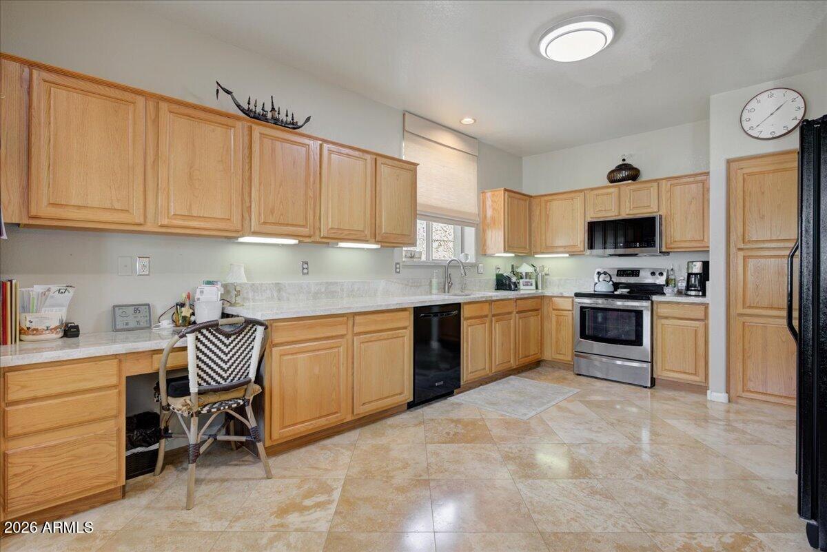 4906 East Wagoner Road Scottsdale, AZ 85254 - Photo 8 of 29 a kitchen with granite countertop stainless steel appliances and white cabinets