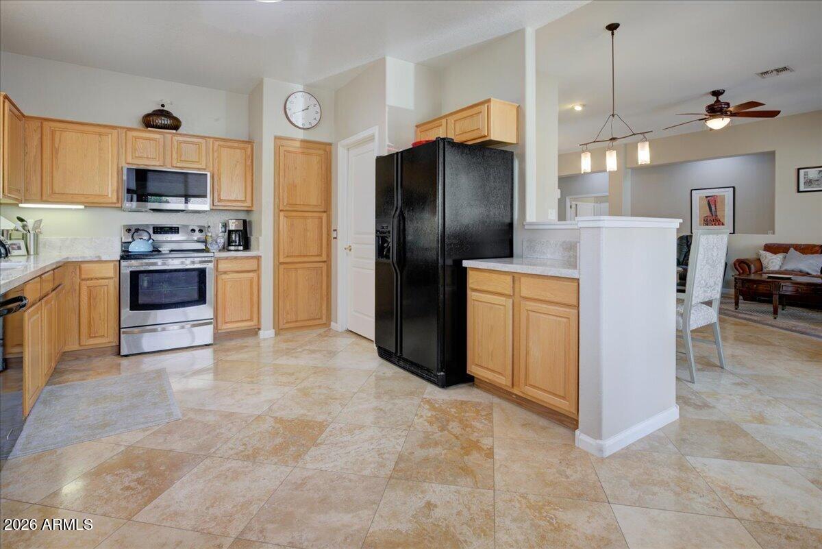 4906 East Wagoner Road Scottsdale, AZ 85254 - Photo 9 of 29 a kitchen with stainless steel appliances granite countertop a refrigerator a stove and a sink