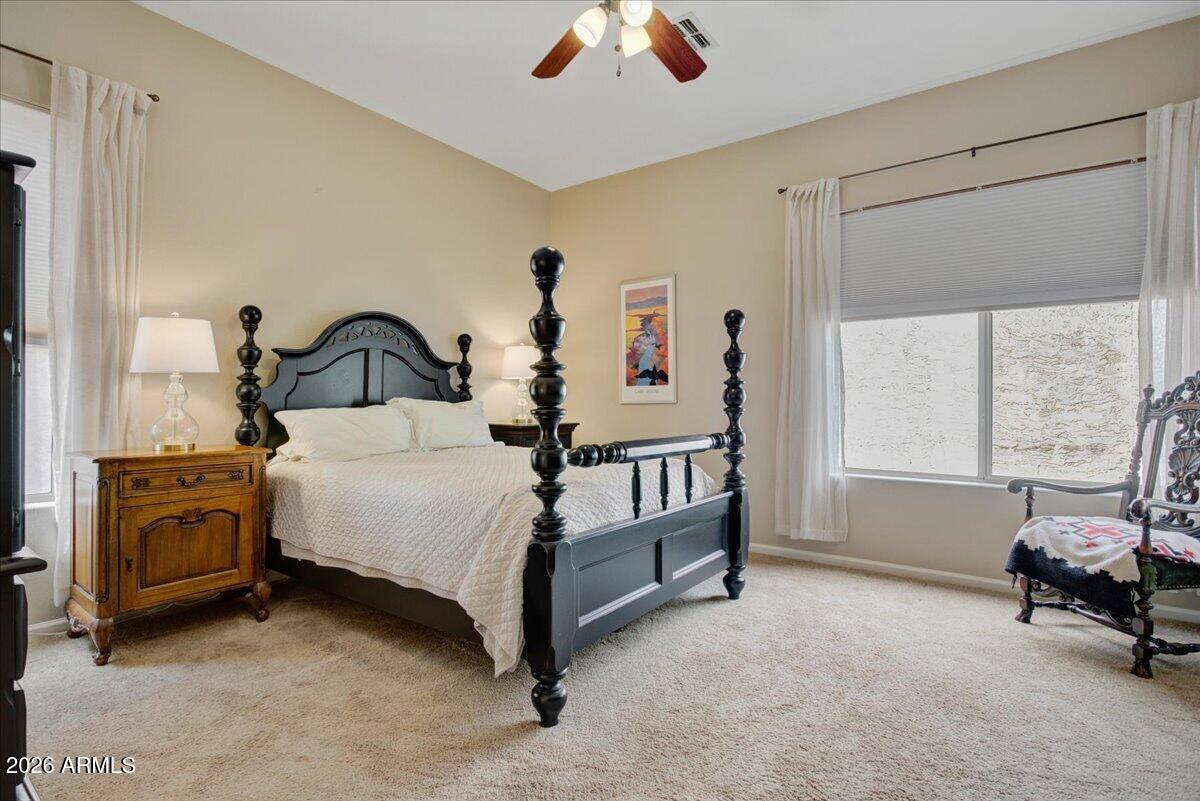 4906 East Wagoner Road Scottsdale, AZ 85254 - Photo 10 of 29 a bedroom with a bed and a chandelier