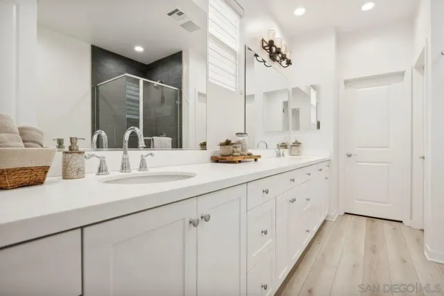 a bathroom with a sink double vanity and a mirror