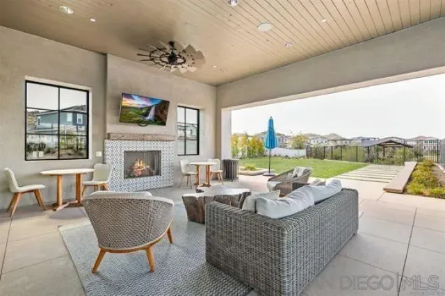 a living room with furniture large window and a fireplace