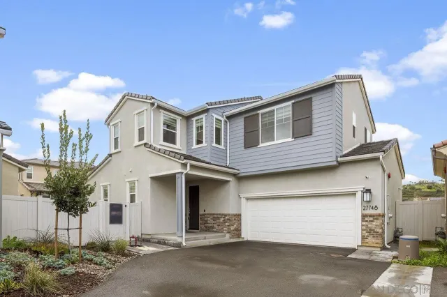 a front view of a house with a garage