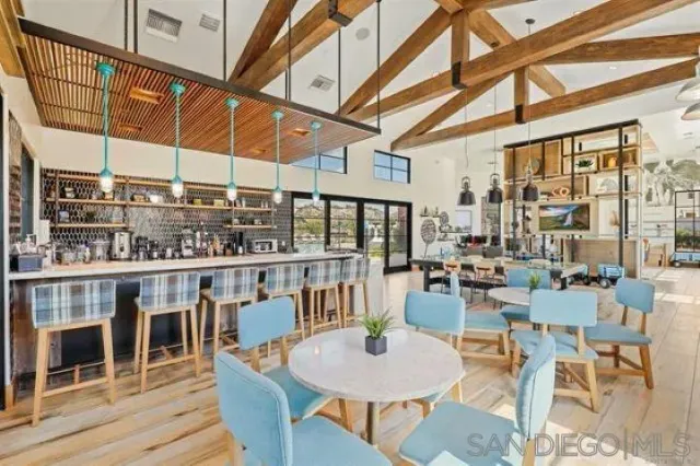a dining room with large glass windows and table