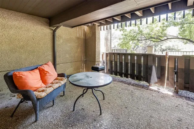 a backyard of a house with table and chairs