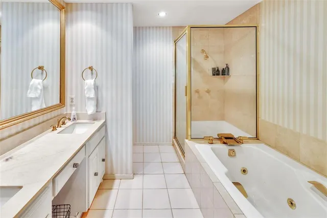 a bathroom with a tub sink and mirror