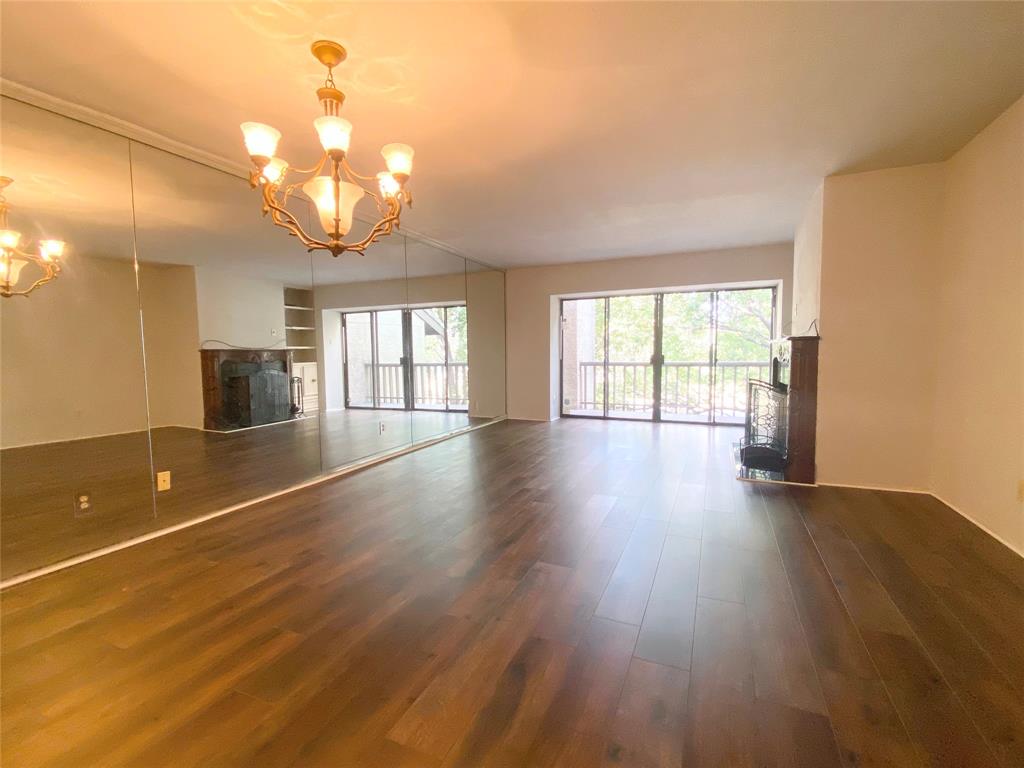 4505 North O'Connor Road, Unit 1122 Irving, TX 75062 - Photo 5 of 18 wooden floor in an empty room with a window