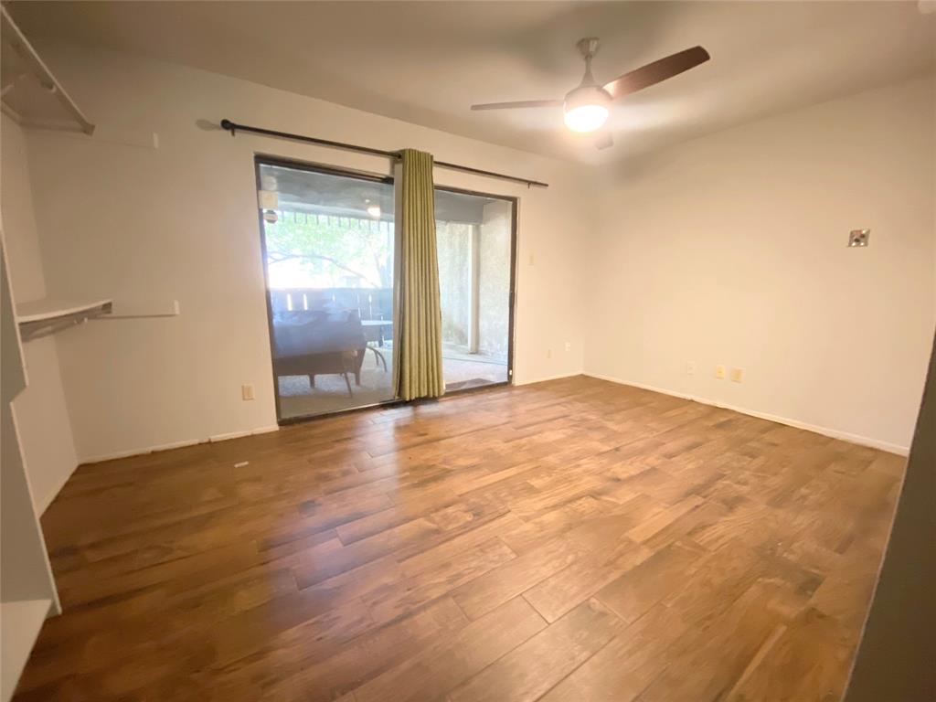 4505 North O'Connor Road, Unit 1122 Irving, TX 75062 - Photo 8 of 18 a view of an empty room with wooden floor and a window