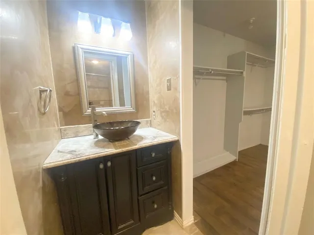 a bathroom with a granite countertop sink a mirror and a