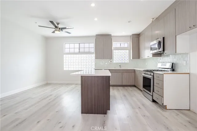a kitchen with wooden floors and white appliances