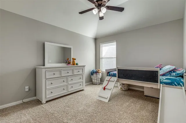 a bedroom with a bed and a dresser in it