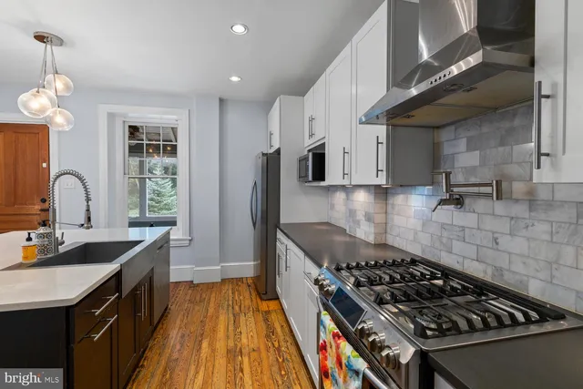 a kitchen with granite countertop a stove and a sink