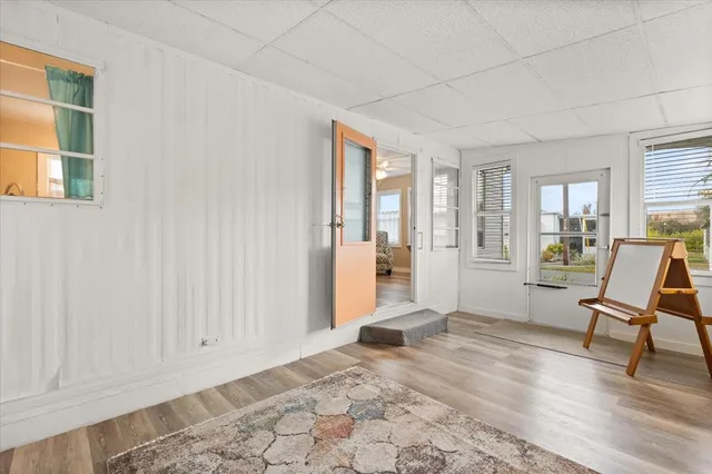 a view of a livingroom with wooden floor and furniture