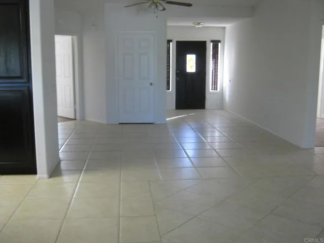 a view of a hallway with wooden cabinets