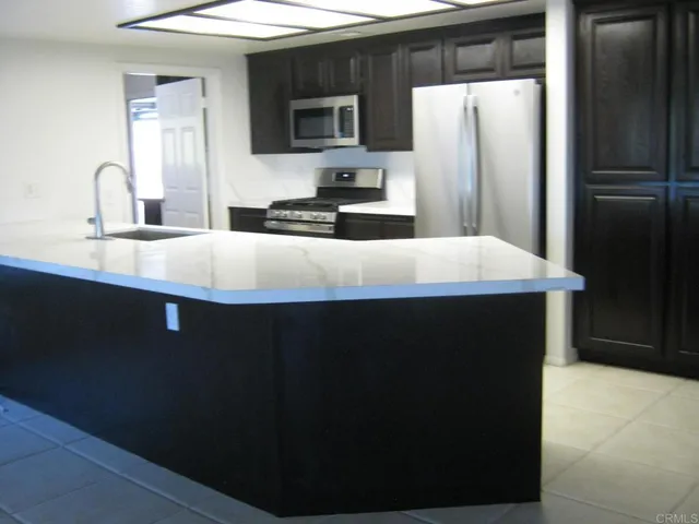 a kitchen with a refrigerator and a sink