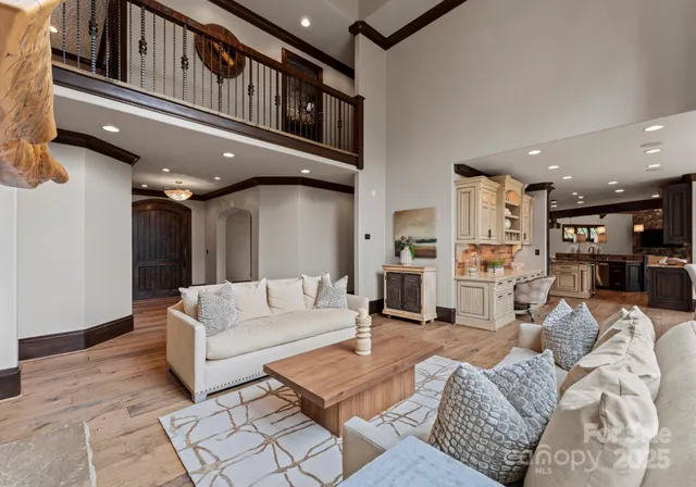 a living room with furniture kitchen view and a table