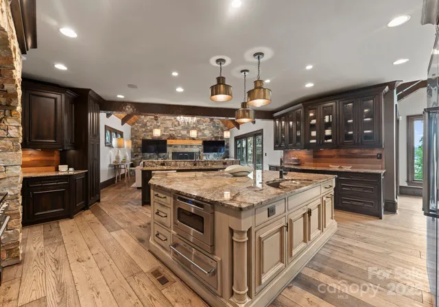 a kitchen with stainless steel appliances granite countertop a stove and a sink