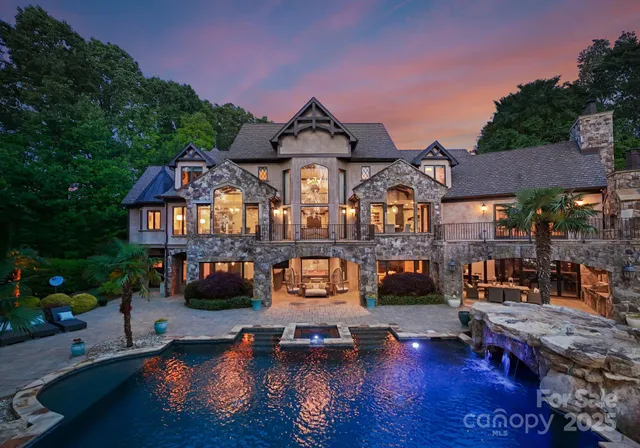 a front view of a house with swimming pool having outdoor seating