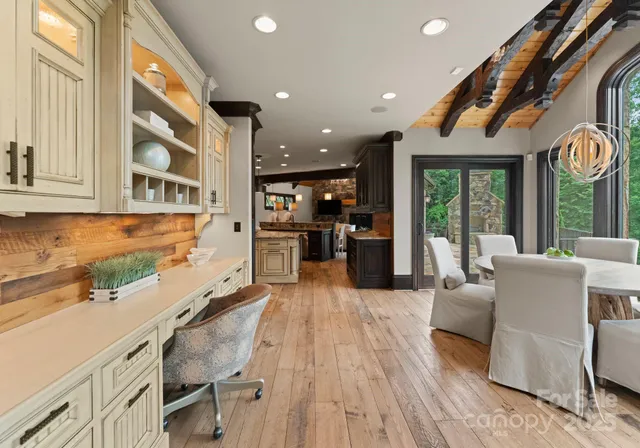 a living room with furniture and large windows