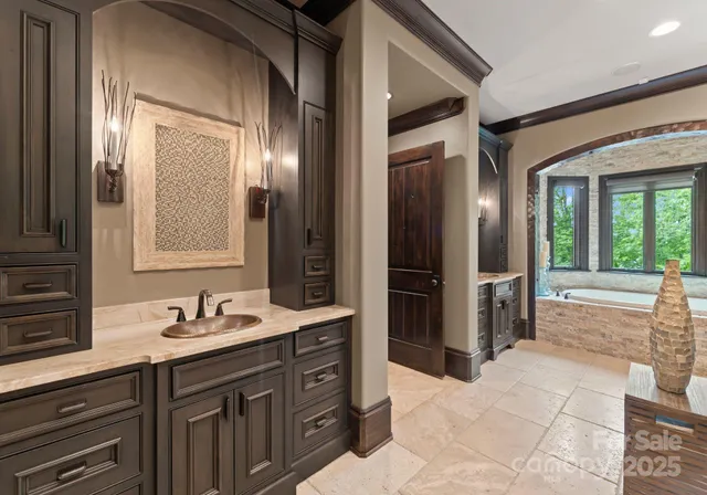 a spacious bathroom with a granite countertop sink mirror and shower
