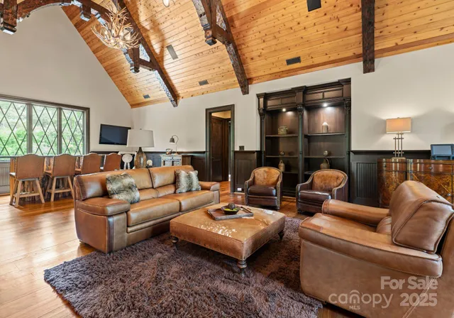 a living room with furniture and a large mirror