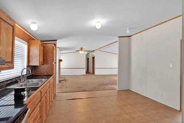 a kitchen with stainless steel appliances granite countertop a sink and a stove