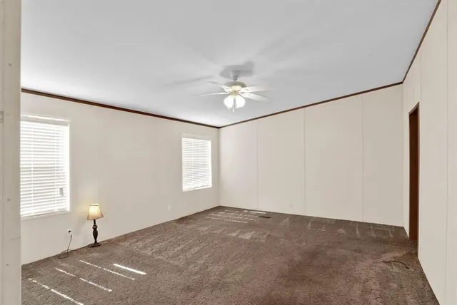 a view of a livingroom with a window and a ceiling fan