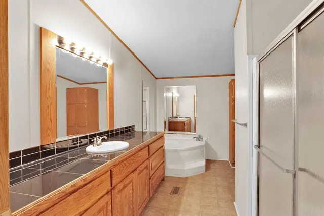 a bathroom with a sink double vanity and a mirror