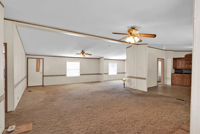a view of a livingroom with a fireplace and window