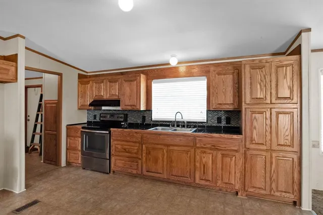 a kitchen with stainless steel appliances granite countertop a refrigerator and a sink